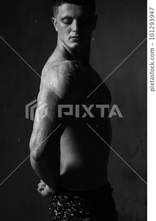 A guy in a great sports uniform in the studio on a gray background. 101293947
