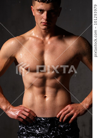 A guy in a great sports uniform in the studio on a gray background. A guy in a great sports uniform in the studio on a gray background. 101293979