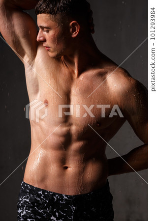 A guy in a great sports uniform in the studio on a gray background. A guy in a great sports uniform in the studio on a gray background. 101293984