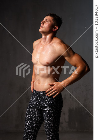 A guy in a great sports uniform in the studio on a gray background. A guy in a great sports uniform in the studio on a gray background. 101294017