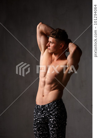 A guy in a great sports uniform in the studio on a gray background. 101294064