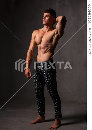 A guy in a great sports uniform in the studio on a gray background. A guy in a great sports uniform in the studio on a gray background. 101294099