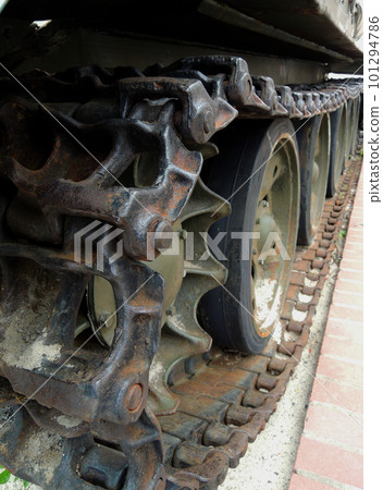 Wheels and suspension of rare tracked war machine with dirt and rust on a tracks  101294786