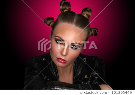 Portrait of a young sassy girl with blond hair in the studio on a pink background. Portrait of a young sassy girl with blond hair in the studio on a pink background. 101295449