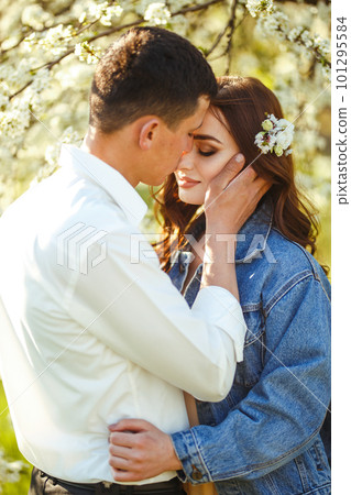 Beautiful loving couple in blooming gardens. Wedding concept. Great sunset light. Lovely newlyweds. Beautiful loving couple in blooming gardens. Wedding concept. Great sunset light. Lovely newlyweds. 101295584