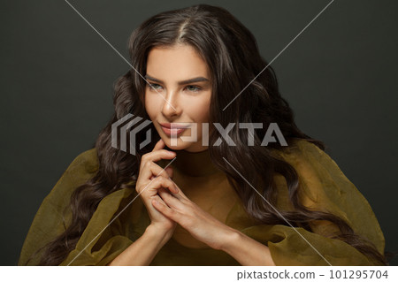 Cute brunette model woman with long perfect hair against black studio wall background Cute brunette model woman with long perfect hair against black studio wall background 101295704