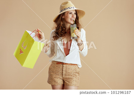 happy 40 years old woman in blouse and shorts isolated on beige 101296187