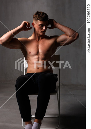 A guy in a great sports uniform in the studio on a gray background. A guy in a great sports uniform in the studio on a gray background. 101296220
