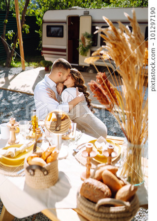 Beautiful wedding couple laugh and kiss relaxing in rv, camping in a trailer. Romantic moment. 101297190