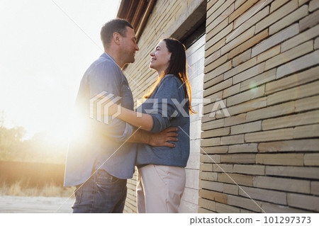 Young man hugging beautiful woman on background of surfboards 101297373