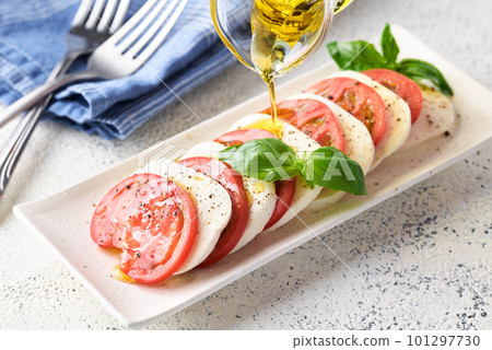 Apply olive oil to caprese Apply olive oil to caprese 101297730