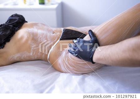 Young blonde woman makes cosmetology procedure in spa salon 101297921