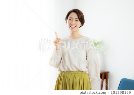 A middle-aged woman looking at the camera and smiling 101298139