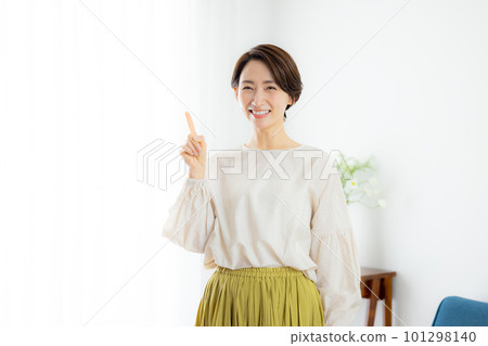 A middle-aged woman looking at the camera and smiling A middle-aged woman looking at the camera and smiling 101298140