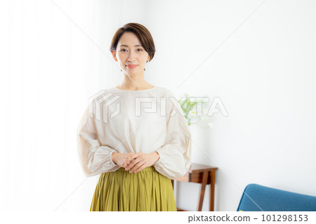 A middle-aged woman looking at the camera and smiling A middle-aged woman looking at the camera and smiling 101298153