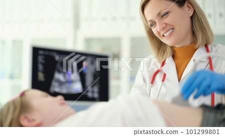 Doctor pediatrician conducting abdominal ultrasound examination of internal organs of child in clinic Doctor pediatrician conducting abdominal ultrasound examination of internal organs of child in clinic 101299801