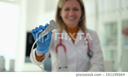 Doctor of ultrasound diagnostics holding probe in hands in clinic closeup 101299864