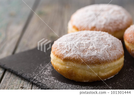 Ruddy delicious donuts berliners on a stone board 101301444