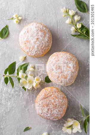 Berliner in powdered sugar with jasmine flowers, top view 101301465