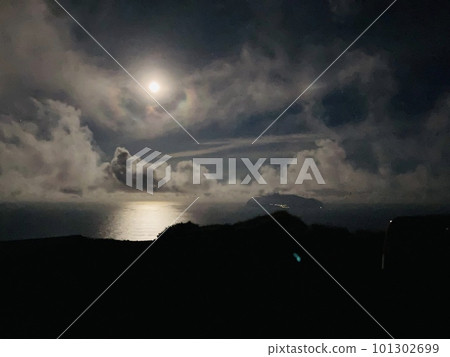 A hazy moon floating in the sea A hazy moon floating in the sea 101302699