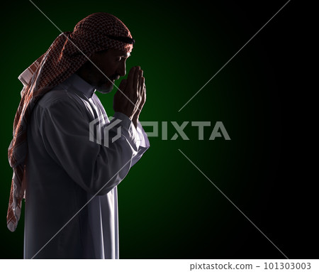 Islamic prayer ritual. Arab Man in Profile Holding Palms in Front of Face, Copy Space. High quality photo Islamic prayer ritual. Arab Man in Profile Holding Palms in Front of Face, Copy Space. High quality photo 101303003