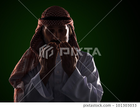 Arab man in prayer with his palms in front of his face. It conveys the devotion and spirituality inherent in Islamic culture. High quality photo Arab man in prayer with his palms in front of his face. It conveys the devotion and spirituality inherent in Islamic culture. High quality photo 101303033