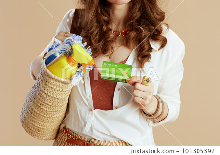 Modern female in blouse and shorts against beige 101305392
