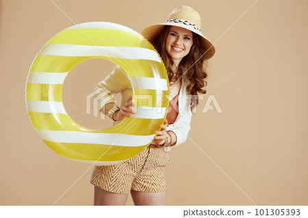 happy modern woman in white blouse and shorts isolated on beige 101305393