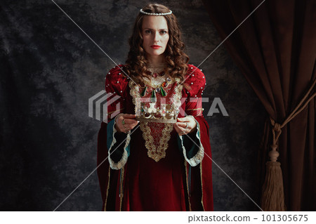 medieval queen in red dress with crown 101305675