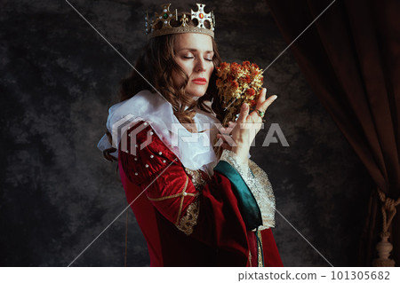 medieval queen in red dress with dried flower and white collar medieval queen in red dress with dried flower and white collar 101305682