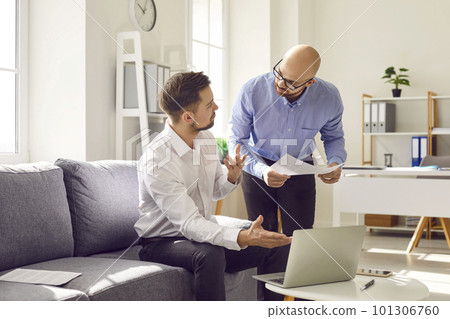 Two young business men at work in office talking and having discussion. 101306760