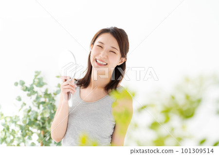 Photo of a woman looking in a hand mirror 101309514