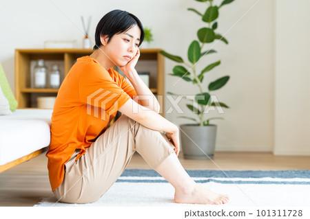 Young woman suffering in the living room 101311728