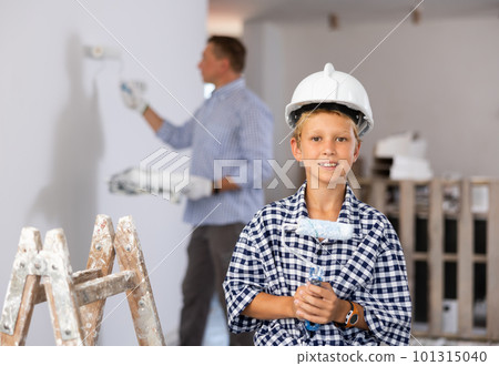 Portrait of positive boy with paint roller. Concept of helping parents to repair apartment 101315040