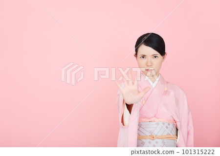 A woman in a kimono that puts out her hand and stops it A woman in a kimono that puts out her hand and stops it 101315222