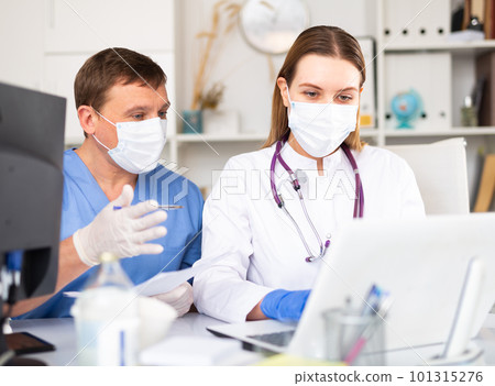 Two physicians working with laptop Two physicians working with laptop 101315276