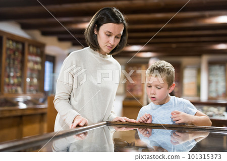 Woman and boy exploring artworks in museum Woman and boy exploring artworks in museum 101315373