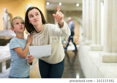 Woman and boy observing sculptures exhibition Woman and boy observing sculptures exhibition 101315392