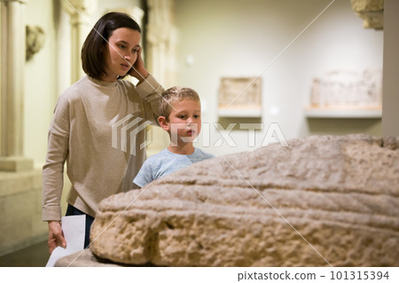 Woman and boy visiting sculptures exhibition 101315394