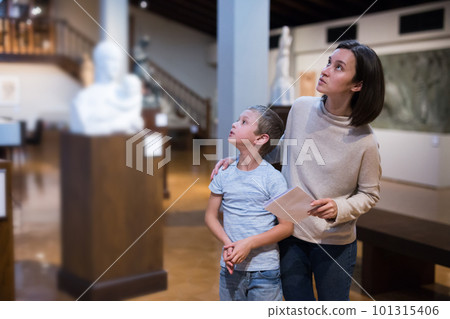 Woman and boy visiting museum 101315406