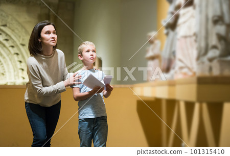 Woman and boy visiting sculptures exhibition 101315410