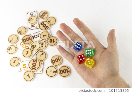 Man's hand with dice and toy money. image of gambling 101315895