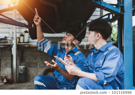 Expert auto mechanic repair and service customer service work on car at garage. automobile car concept 101316996
