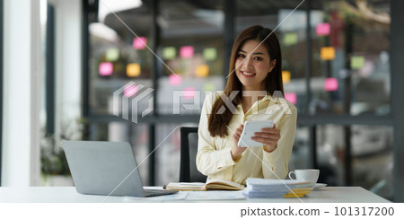 Beautiful Asian Banker or Accountant makes financial report and tax, analyzes profits. Accountant checks status of financial Beautiful Asian Banker or Accountant makes financial report and tax, analyzes profits. Accountant checks status of financial 101317200