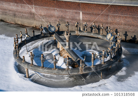 equipment with pipes and taps with illumination in an empty fountain in winter 101318508