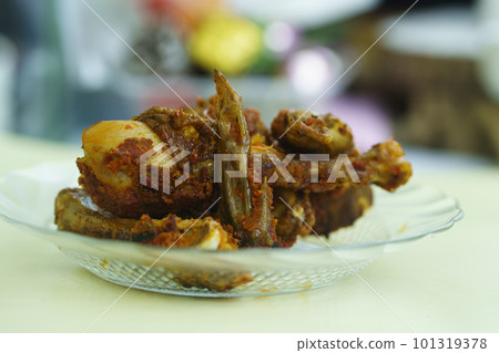 Grilled chicken with spicy marination served on clear plate on the table. Grilled chicken with spicy marination served on clear plate on the table. 101319378