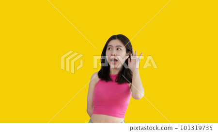 Asian woman eavesdropping or overhearing secret conversation isolated on yellow background, Gossip, Listening, Yellow background studio portrait. Asian woman eavesdropping or overhearing secret conversation isolated on yellow background, Gossip, Listening, Yellow background studio portrait. 101319735