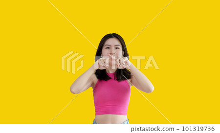 Asian woman doing silent gesture with finger, Noiseless signal transmission, Noiseless symbol, Hide a secret, Crossed hands, Do not speak, Shut your mouth, Isolated on yellow background . Asian woman doing silent gesture with finger, Noiseless signal transmission, Noiseless symbol, Hide a secret, Crossed hands, Do not speak, Shut your mouth, Isolated on yellow background . 101319736