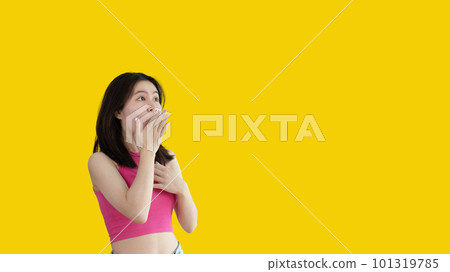Asian woman acting shocked or surprised isolated on a Yellow background,  Looking camera, Concept acts according to the emotions and feelings of excitement and shock, Yellow background, Copy space. 101319785