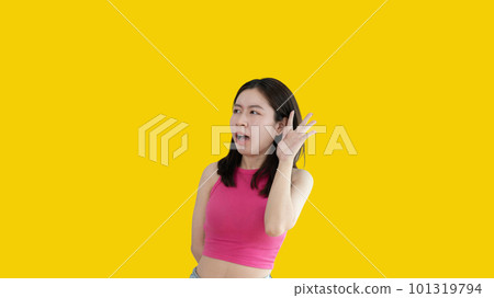 Asian woman eavesdropping or overhearing secret conversation isolated on yellow background, Gossip, Listening, Yellow background studio portrait. Asian woman eavesdropping or overhearing secret conversation isolated on yellow background, Gossip, Listening, Yellow background studio portrait. 101319794
